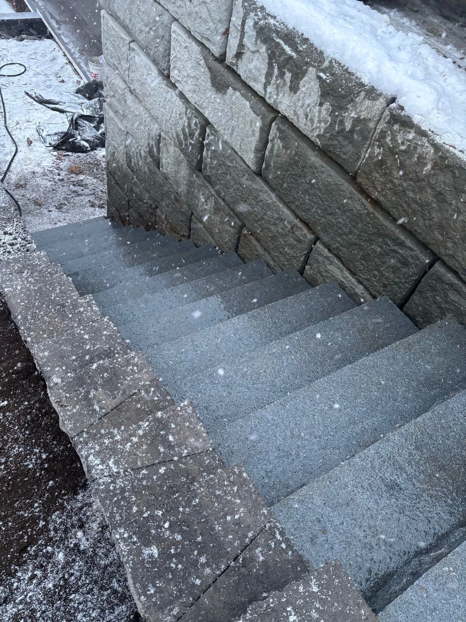 Granite steps beside a stone retaining wall