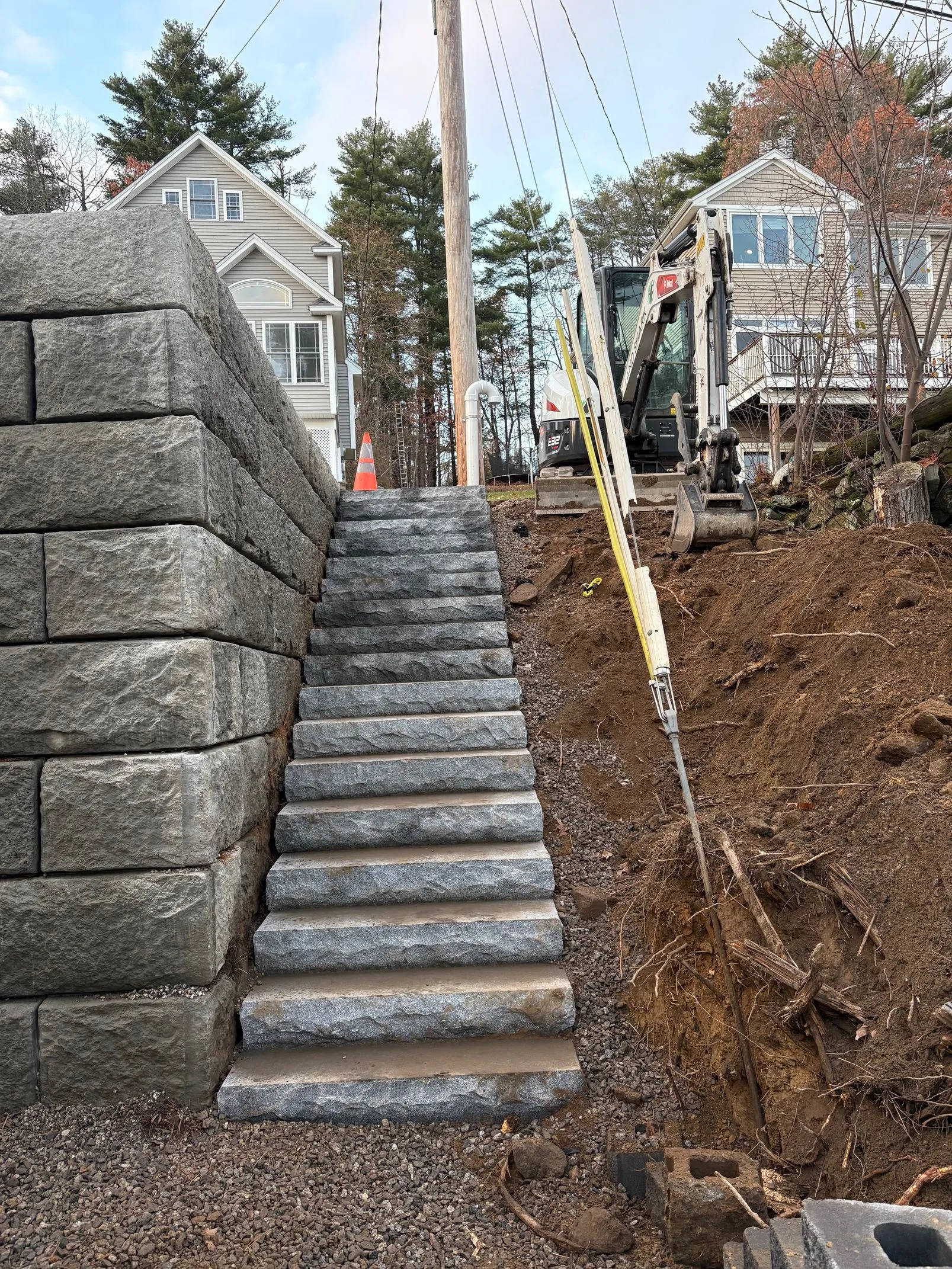 Stone retaining wall and steps during site preparation and grading